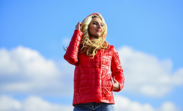 Fashion outfit Windy day Matching style and class with luxury and comfort Girl red jacket cloudy sky Wind of changes Female psychology Woman fashion model outdoors Woman enjoy cool weather