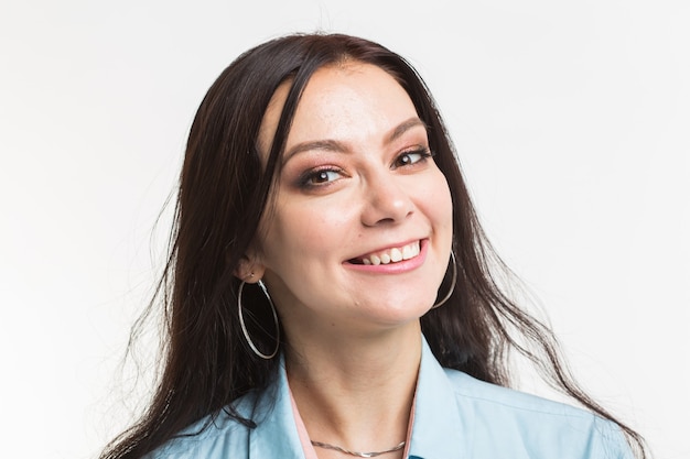 Fashion and people concept - Close up portrait of beautiful smiling young woman.