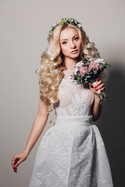 Fashion photo of young bride girl with long curly hair