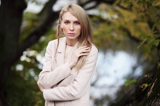 Fashion portrait of beautiful blonde woman in stylish clothes outdoor in autumn.