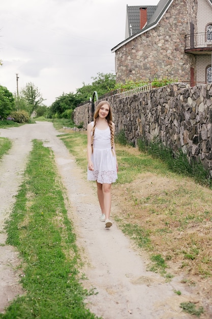 Fashion portrait of beautiful boho style girl near scandinavian house