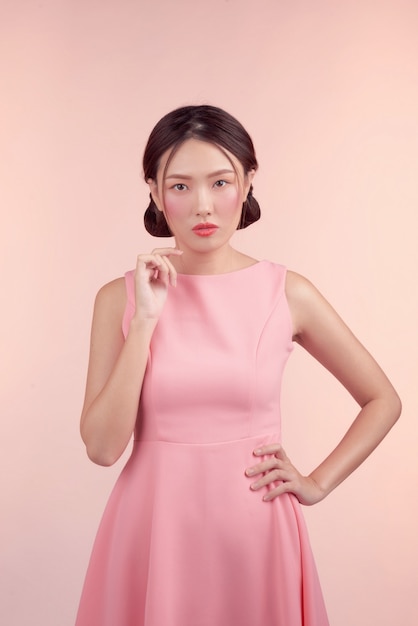 Fashion portrait of a beautiful young woman in a pretty dress