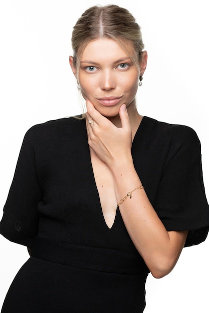 Fashion portrait of a charming white caucasian girl with jewelry in black clothes