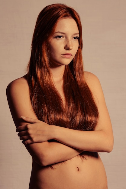 Fashion portrait of redhead woman with long hair