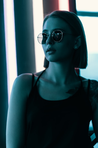 Fashion portrait of young attractive girl in sunglasses