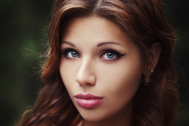 Fashion portrait of young model woman on urban background