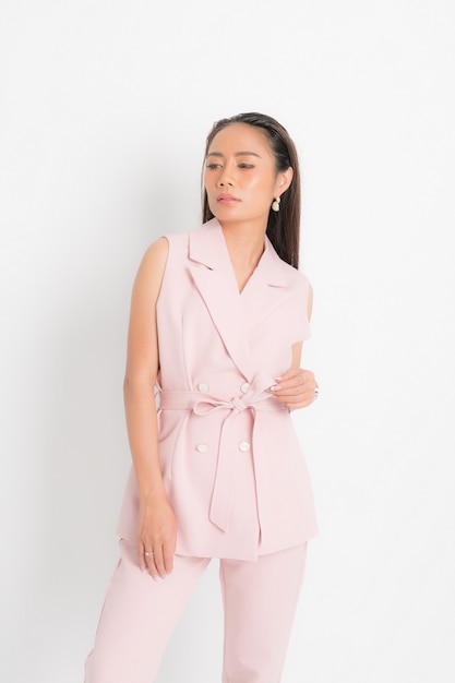 Fashion style catalog clothing for business woman black long hair natural make up wear pink suit costume perfect body shape suit at studio shoot on white background and shadow.