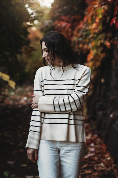 Fashion woman on a background of red and yellow autumn leaves