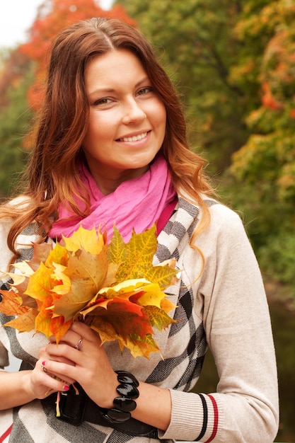 Fashion woman walking in autumn park