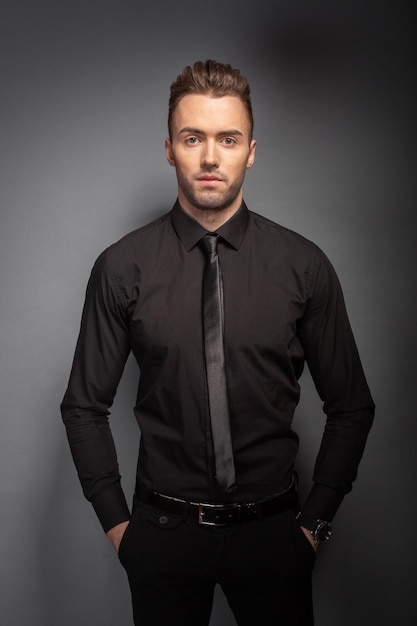 Fashion young man on dark background