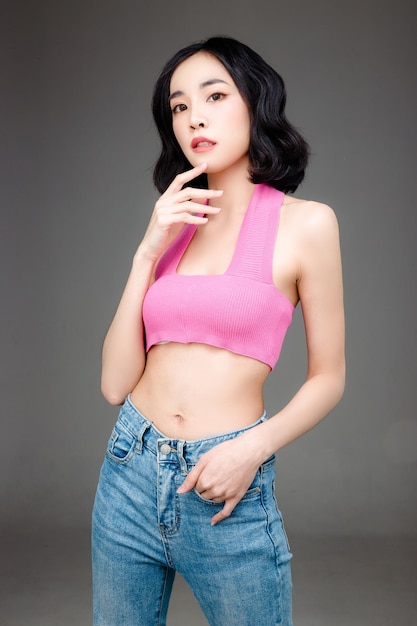 Fashionable asian woman short hair with Perfect body Cute female model with natural makeup and sparkling eyes on white isolated background Facial treatment Cosmetology beauty Concept