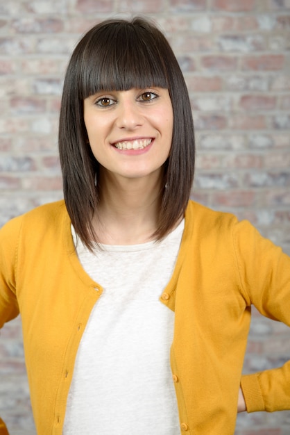 Fashionable brunette wearing bright yellow clothes