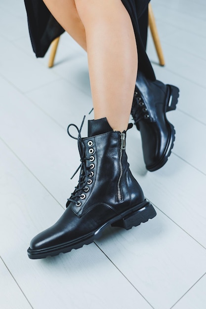 Fashionable leather boots with laces on a woman's leg closeup fashionable New collection of leather autumn women's shoes