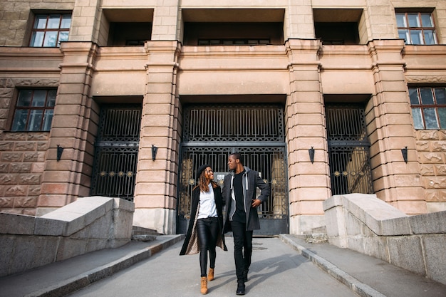 Fashionable pedestrians. Happy couple on street. Smiling black people in relationships, joyful mood, good weather, happiness concept