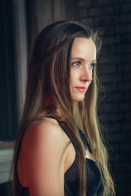 Fashionable sexy girl poses in a dark studio