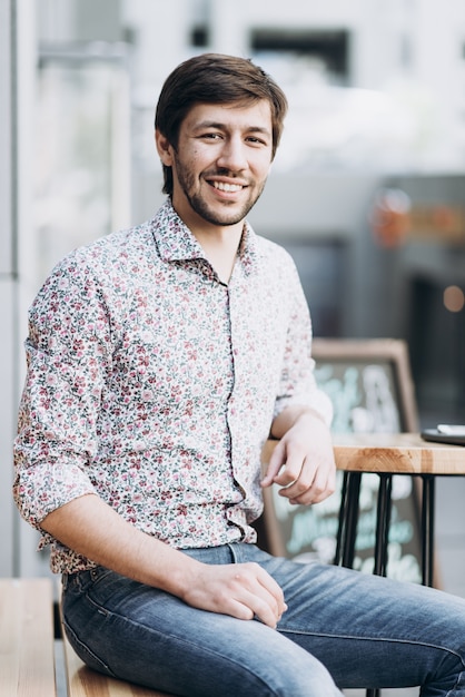 Fashionable smiling man in urban setting