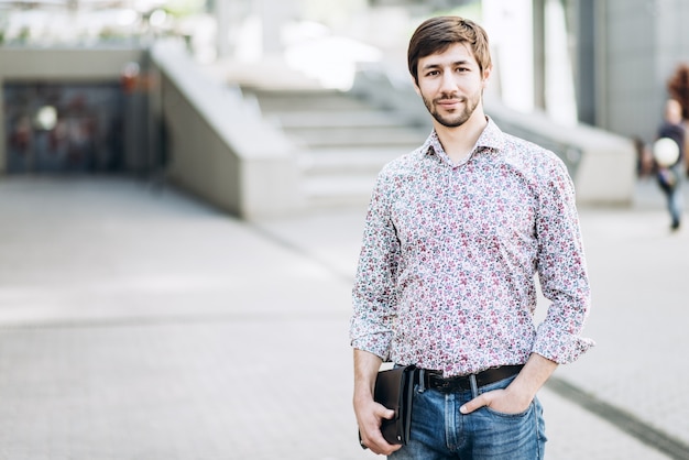 Fashionable smiling man in urban setting