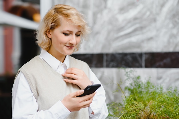 Fashionable woman talking by phone at outdoors cafe