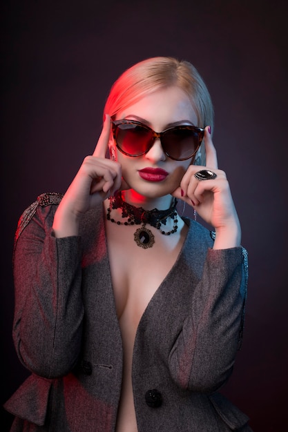 Fashionable young  blonde woman with decollete and wearing chocker