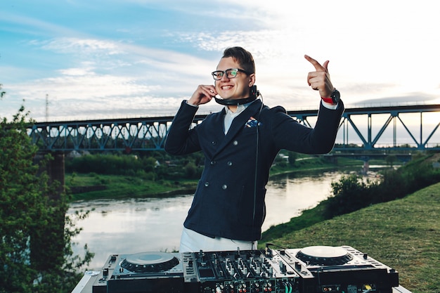 Fashionable young guy with DJ console to have fun