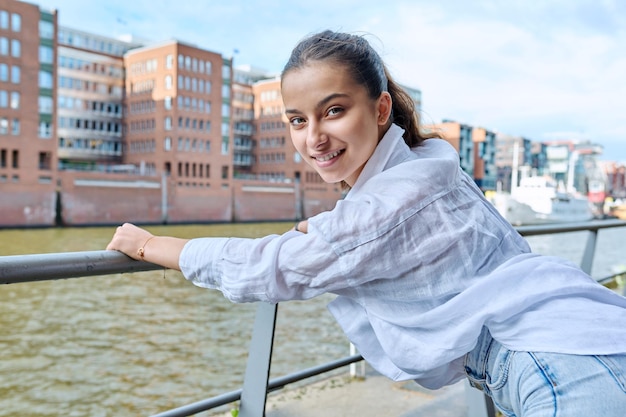 Fashionable young teenage girl posing in a port city