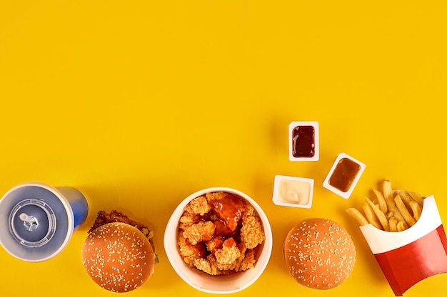 Fast food dish top view Meat burger potato chips and wedges Take away composition French fries hambu