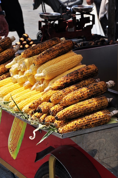 Fast food. Fried and fresh cobs of corn. Fast food kiosk counter.