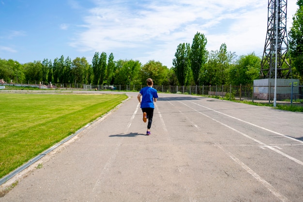 Fast speed runner on the stadium sport track outdoor before the championships