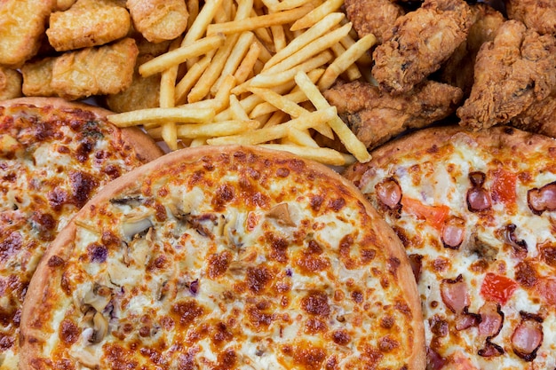 Fastfood chicken nuggets, legs, pizzas and fry potatos