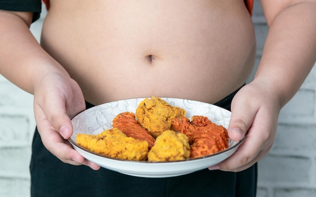 Fat boyxAxA holding a plate of fried chicken