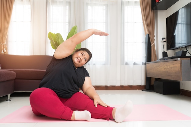 Fat woman asian exercising at home, Sport and recreation idea concept.