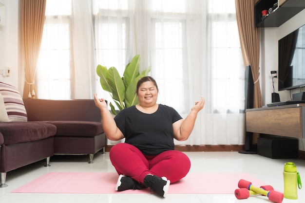 Fat woman asian exercising relaxation vitality on lotus position at home, Sport and recreation idea concept.