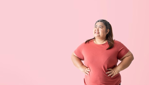 Fat woman thinking and looking isolated on pink background Clipping paths for design work empty free space