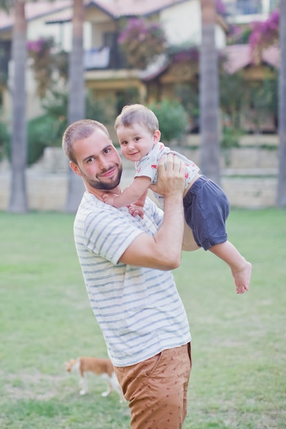 Father and baby walking in park