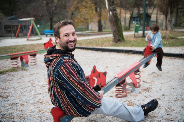 father and  child having fun together  in park playground happy family concept