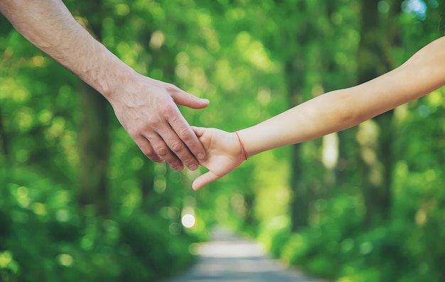 Father and child holding hands