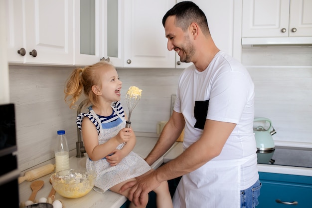 Father and daughter cooking together