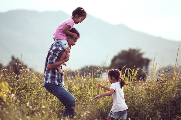 Father and daughter having fun and playing together in the cornfield