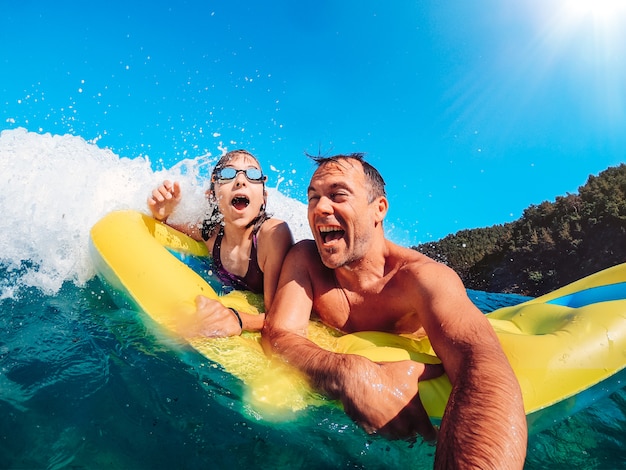 Father and daughter having fun in the sea