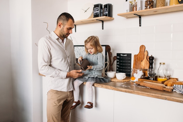 Father and daughter in kitchen at home