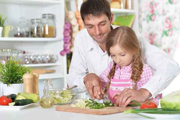 Father and daughter preparing salad