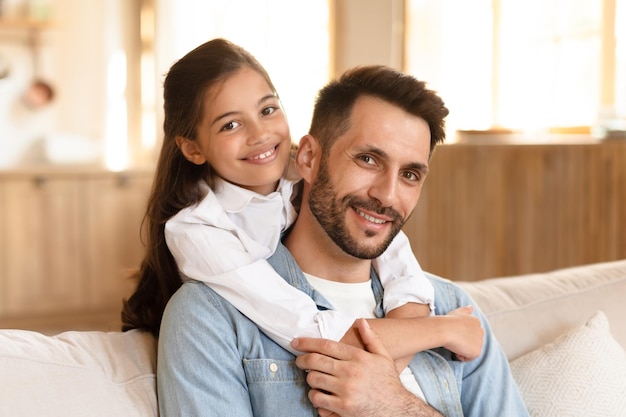 Father and daughter smiling at the camera