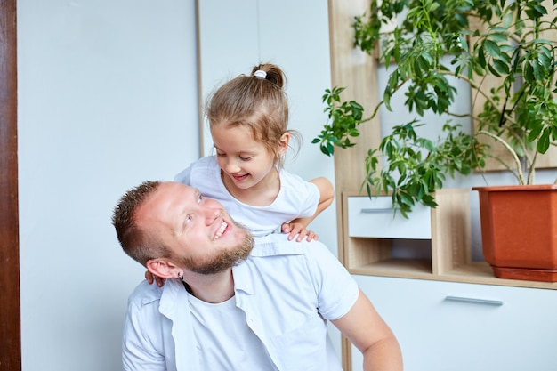 Father and daughter in white spending time at home