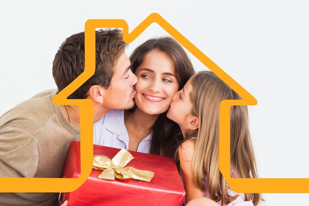 Father and his daughter offering a red gift against house outline