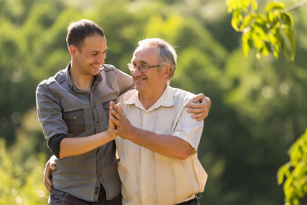 Father and his son looking at the camera in the garden