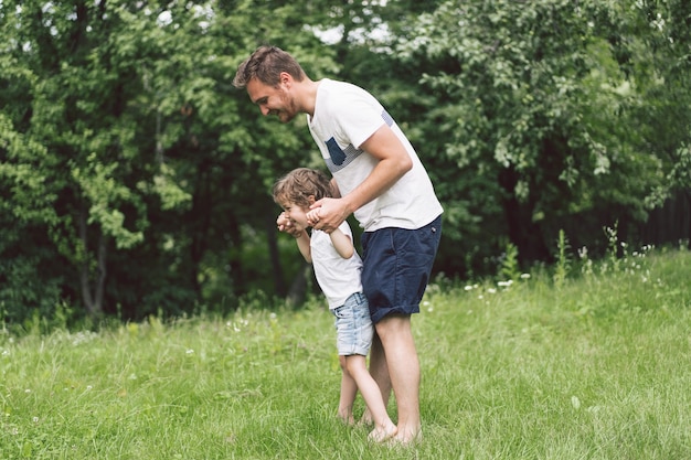 Father and his son playing and hugging in outdoors