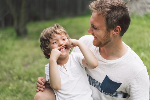 Father and his son playing and hugging in outdoors