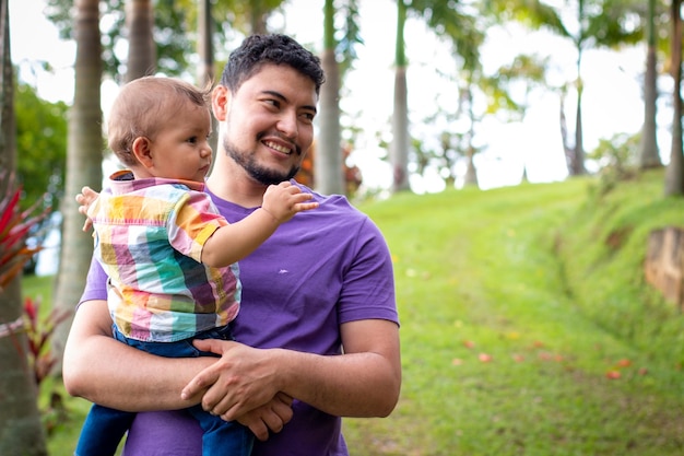 Father holding his son in his arms father and son curious in nature