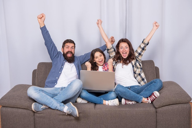 Father mother and child use laptop. family blog. happy parents with kid girl study online. happy mom dad and daughter shopping on cyber monday. modern education and communication. video call.