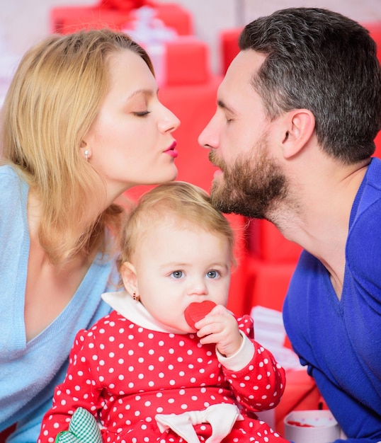 Father, mother and doughter child. Shopping online. Valentines day. Red boxes. Happy family with present box. Love and trust in family. Bearded man and woman with little girl. Totally in love.